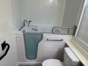 Walk-in bathtub with adjustable shower wand