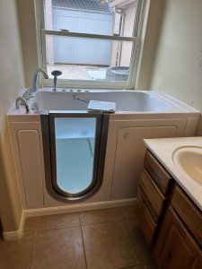 Modern walk-in tub installed in renovated bathroom