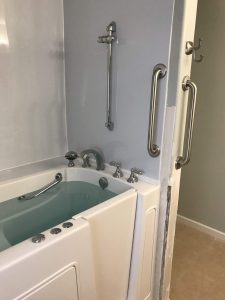 Bathtub surround with tile finish and grab bars