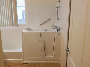 Low-step walk-in bathtub with textured floor