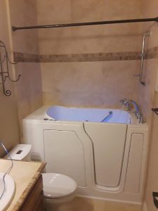 Walk-in bathtub with easy-access door and handrails