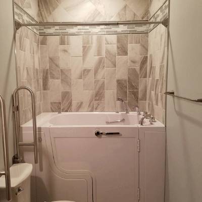 Compact walk-in tub designed for narrow spaces