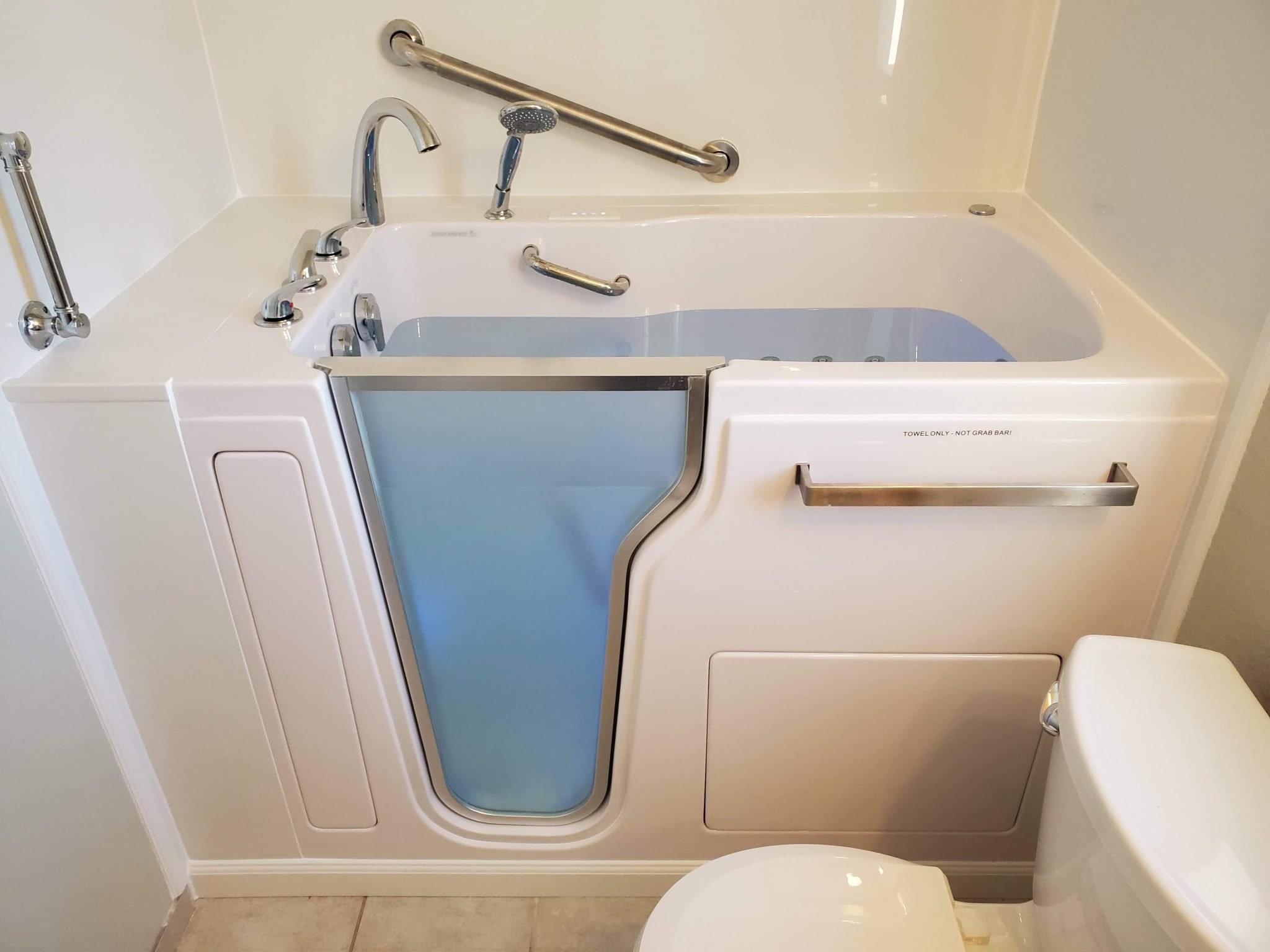 Walk-in bathtub with easy-access door and handrails